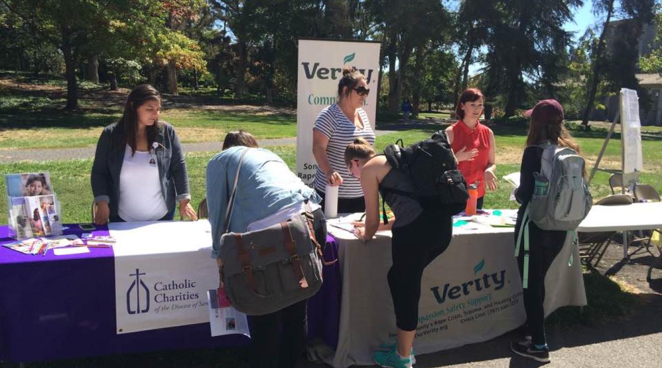 Students signing up for opportunities from Catholic Charities and Verity at the 2016 Fair.