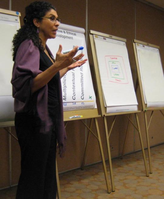 Nanci Luna Jiménez speaking in front of poster presentations