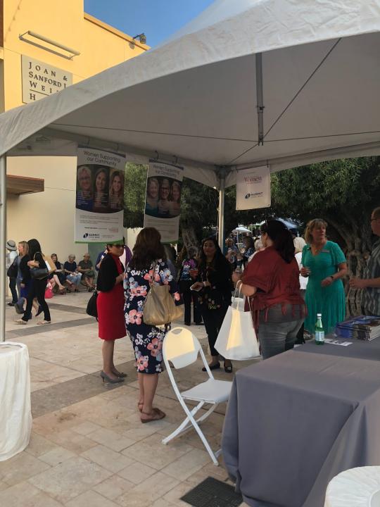 People mingling at the Women Supporting Women tabling